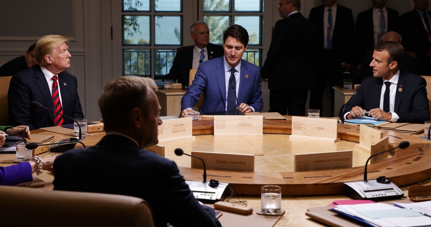 President Donald Trump talks with Canadian Prime Minister Justin Trudeau and French President Emmanuel Macron during a G7 Summit working session on June 8, 2018. (AP Photo/Evan Vucci)