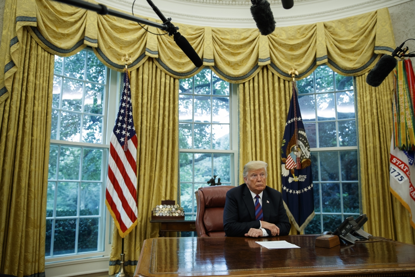 President Donald Trump listens during a phone call with Mexican President Enrique Pena Nieto about a trade agreement between the United States and Mexico on August 27, 2018. (AP Photo/Evan Vucci)