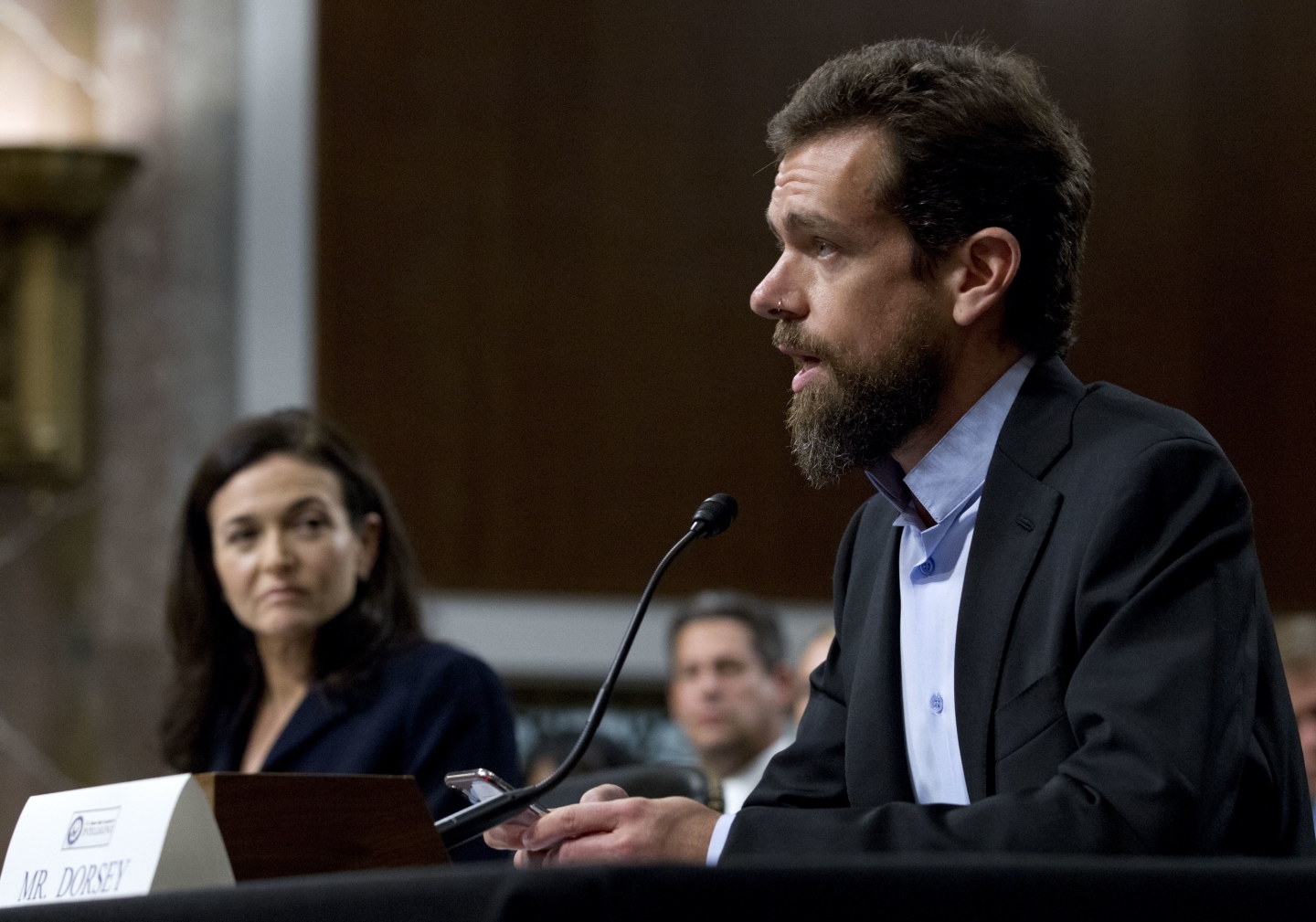 Twitter CEO Jack Dorsey, accompanied by Facebook COO Sheryl Sandberg, testify before the Senate Intelligence Committee in Washington on September 5, 2018. (AP Photo/Jose Luis Magana)