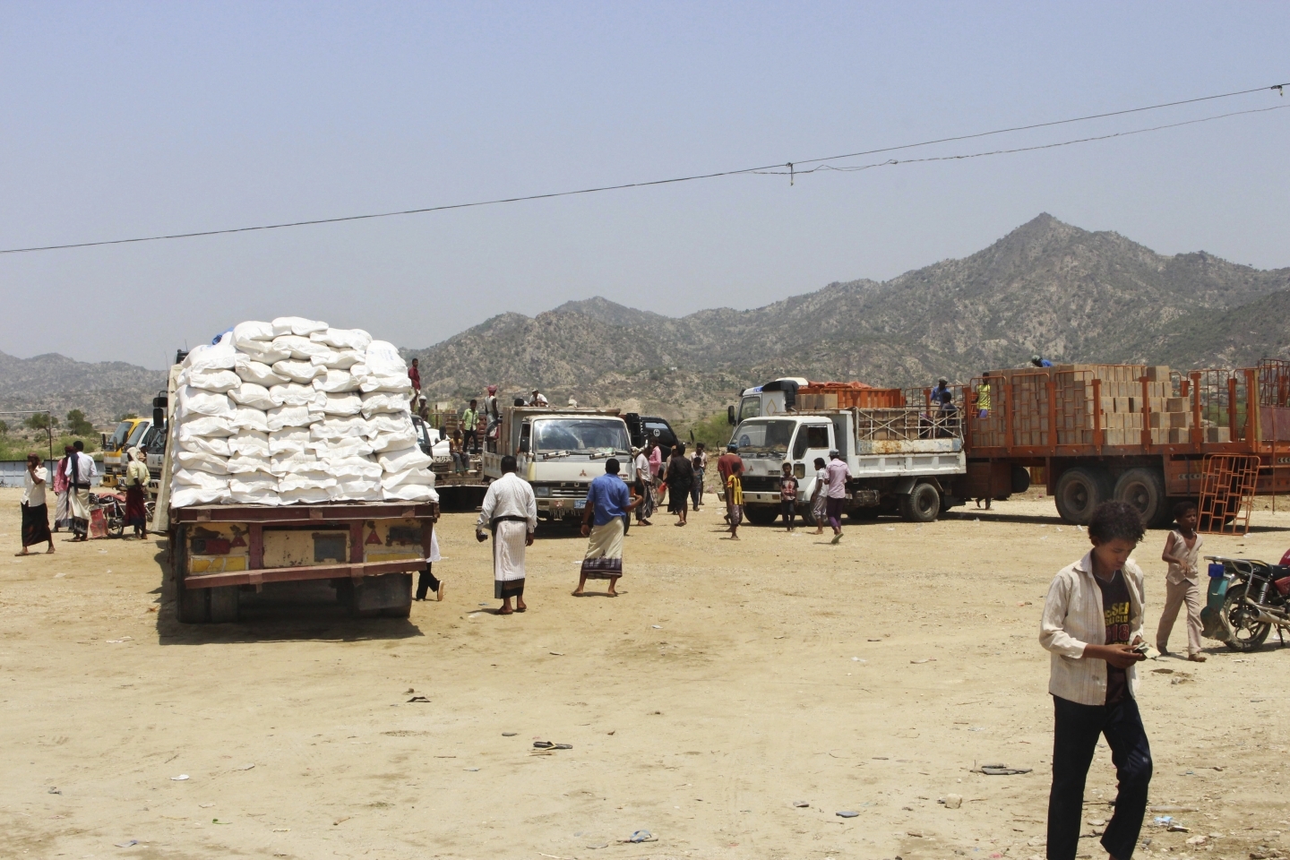 World Food Programme (WFP) aid arrives in in Aslam, Hajjah, Yemen. The programme recently accused the government of redirecting aid to fund the war and insisted that aid recipients participate in a biometric identity-tracking system, sparking a data governance standoff. (AP Photo/Hammadi Issa)