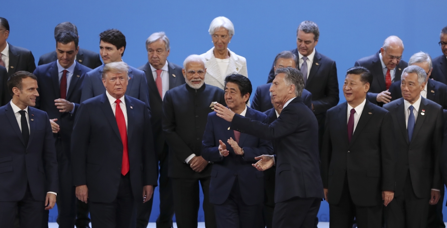 Argentina's President Mauricio Macri points the way to the opening session room after the group photo of the G20 Leader's Summit in Buenos Aires, Argentina on November 30, 2018. (AP Photo/Ricardo Mazalan)