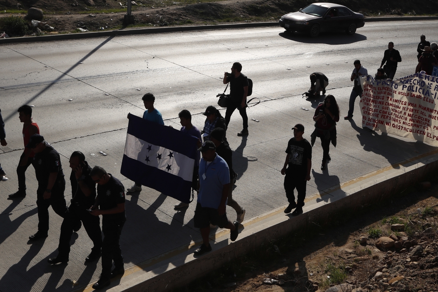 On December 11, 2018, Honduran migrants marched to the US consulate in Tijuana, Mexico, calling for authorities to speed up the asylum application process. (AP Photo/Moises Castillo)