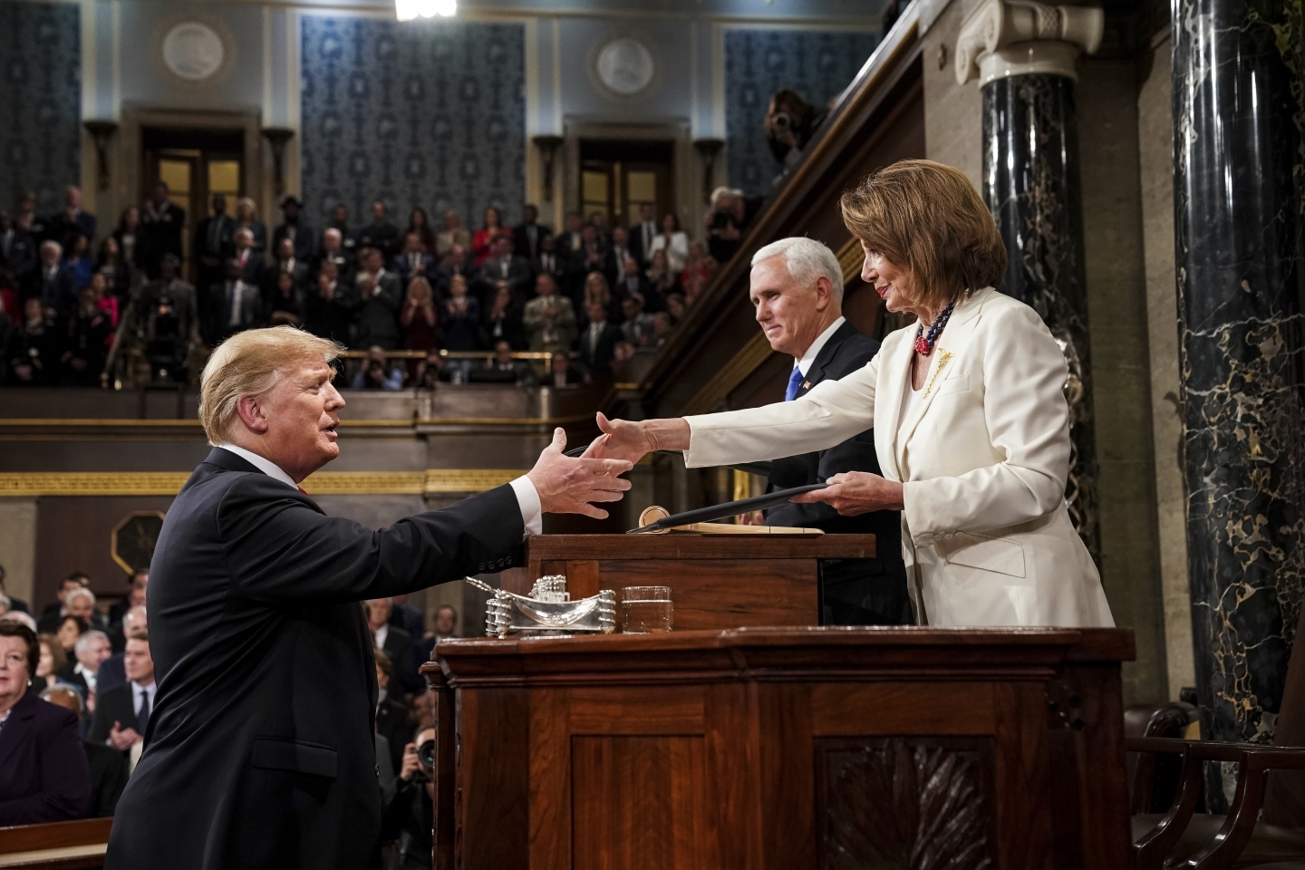 President Donald Trump shakes hands with House Speaker Nancy Pelosi as he arrives in the House chamber before giving his State of the Union address on February 5, 2019. (Doug Mills/The New York Times via AP, Pool)