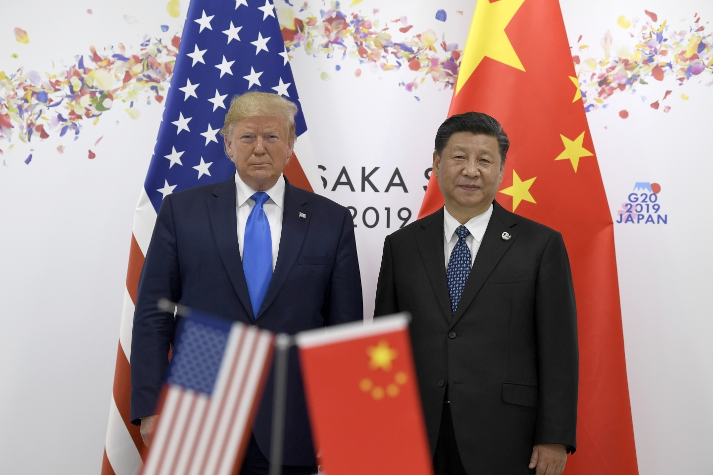 President Donald Trump, left, poses for a photo with Chinese President Xi Jinping during a meeting on the sidelines of the G20 summit in Osaka, Japan on June 29, 2019. (AP Photo/Susan Walsh)