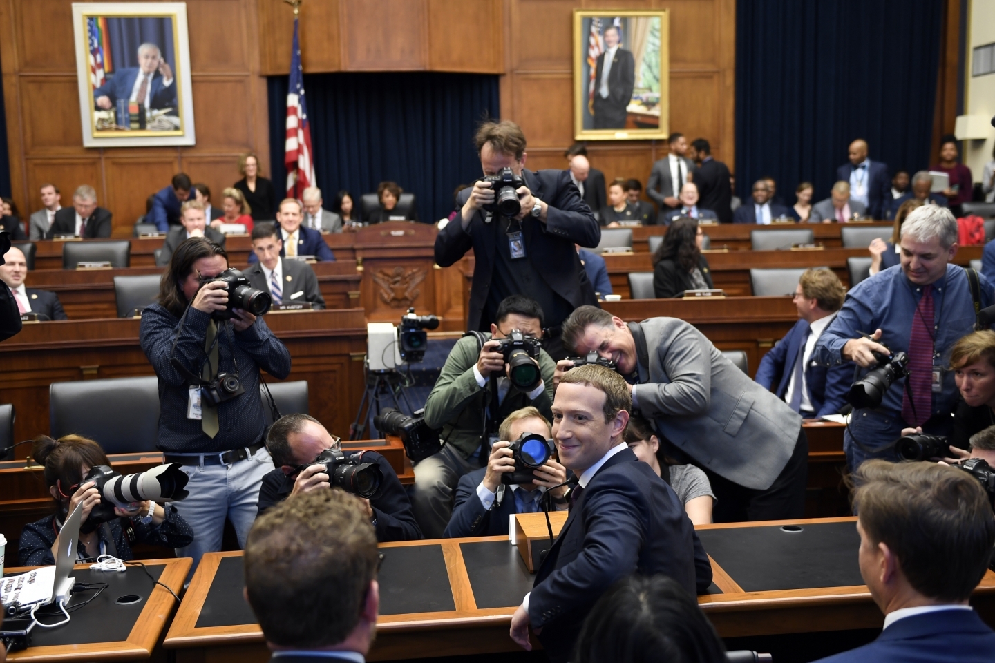Facebook Chief Executive Officer Mark Zuckerberg turns back and smiles after arriving for a hearing before the House Financial Services Committee on Capitol Hill on October 23, 2019. (AP Photo/Susan Walsh)