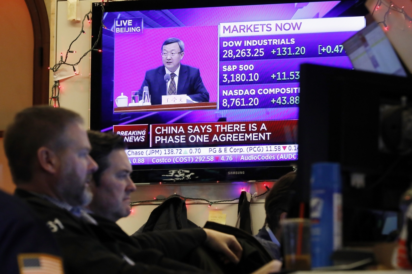 A television screen on the floor of the New York Stock Exchange, Friday, Dec. 13, 2019. (AP Photo/Richard Drew)