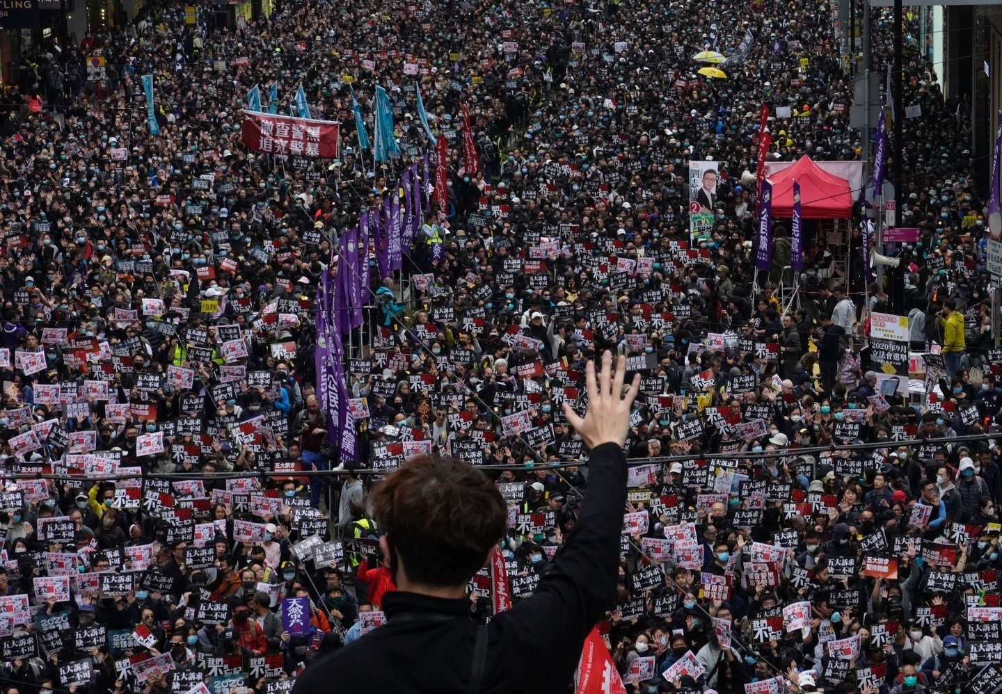 A protestor shows a "five demands" gesture while participating in the annual pro-democracy march in Hong Kong, on January 1, 2020. (AP Photo/Vincent Yu)