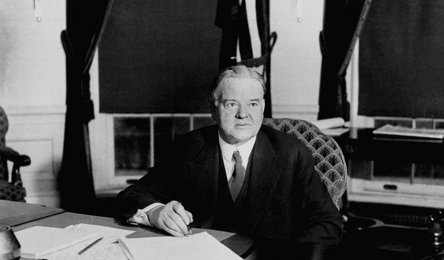 President Herbert Hoover signs unemployment and drought relief bills during the Great Depression. Dec. 20, 1930. (AP Photo)