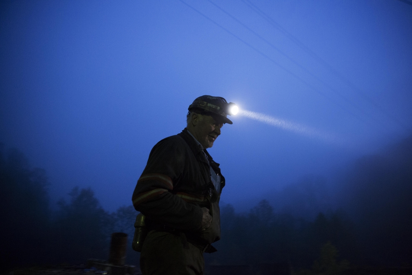 Coal miner Scott Tiller prepares to head into an underground mine at dusk in Welch, West Virginia (AP Photo/David Goldman)