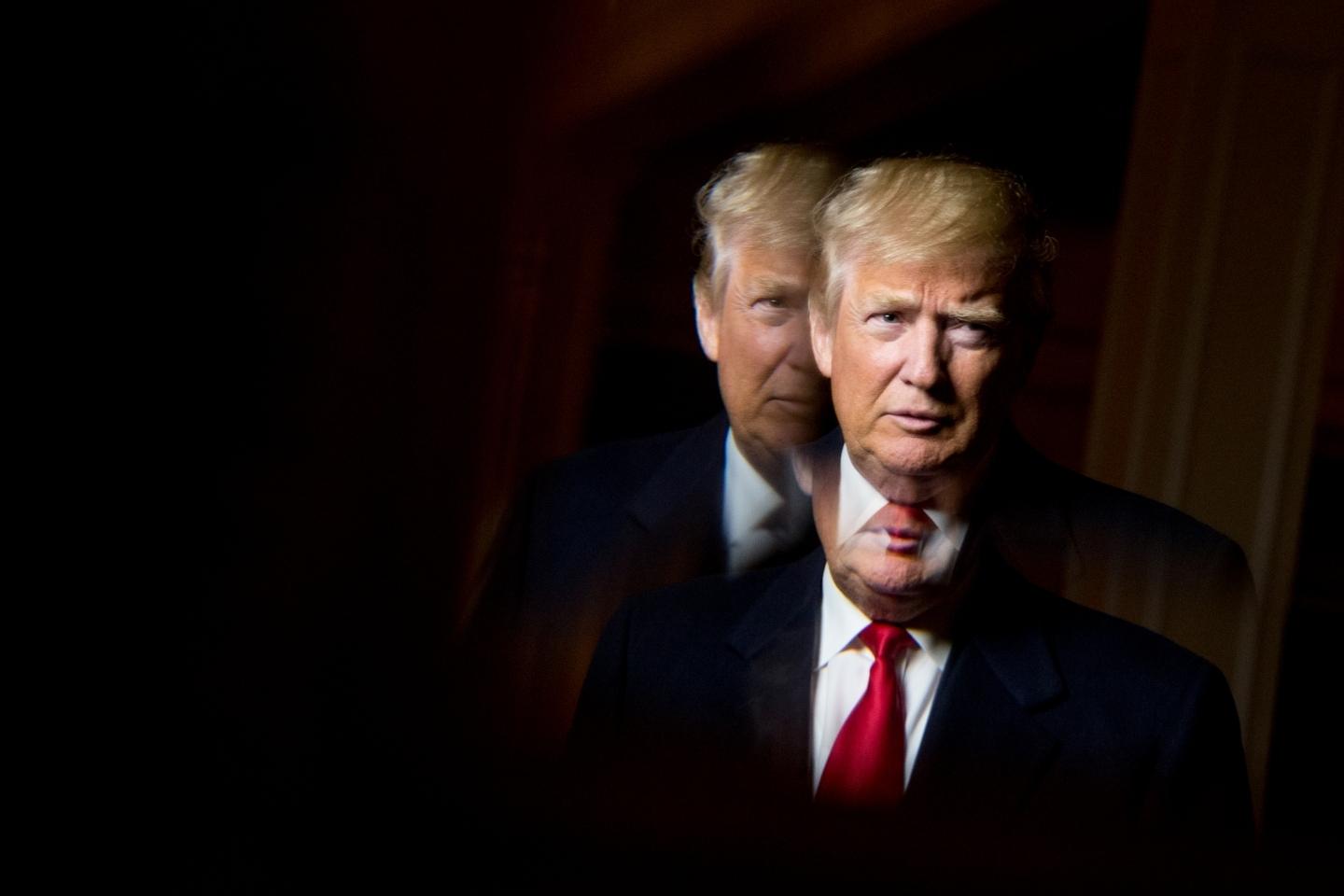 President-elect Donald Trump, seen in reflection, poses for a portrait (AP Photo/Andrew Harnik)