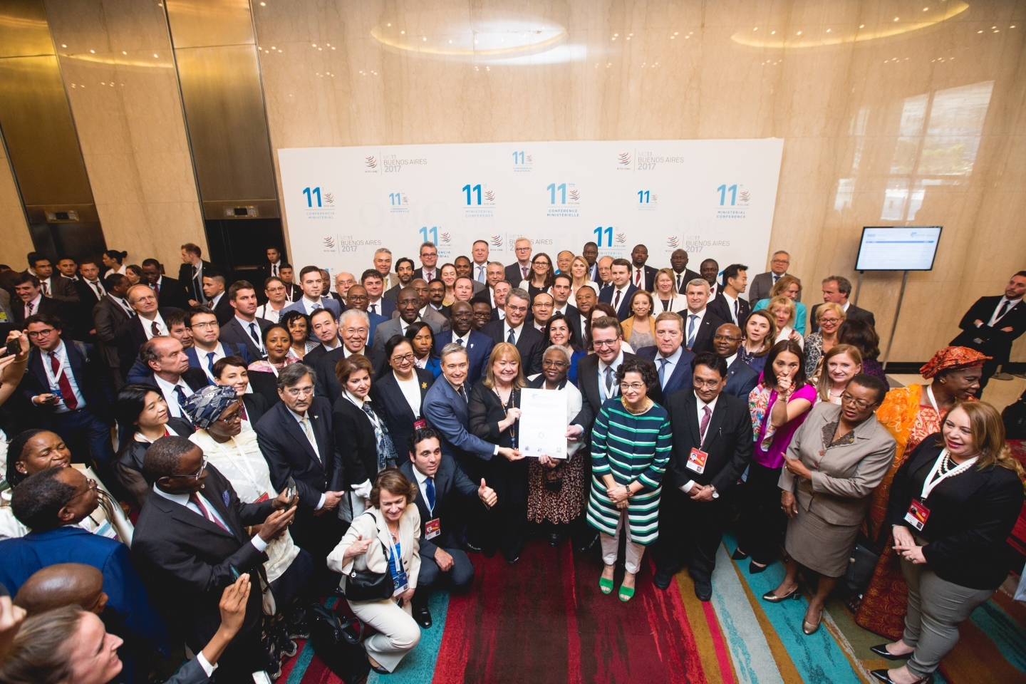 Declaration signatories pose for a photo at the World Trade Organization ministerial conference in Buenos Aires. (WTO/Cuika Foto)