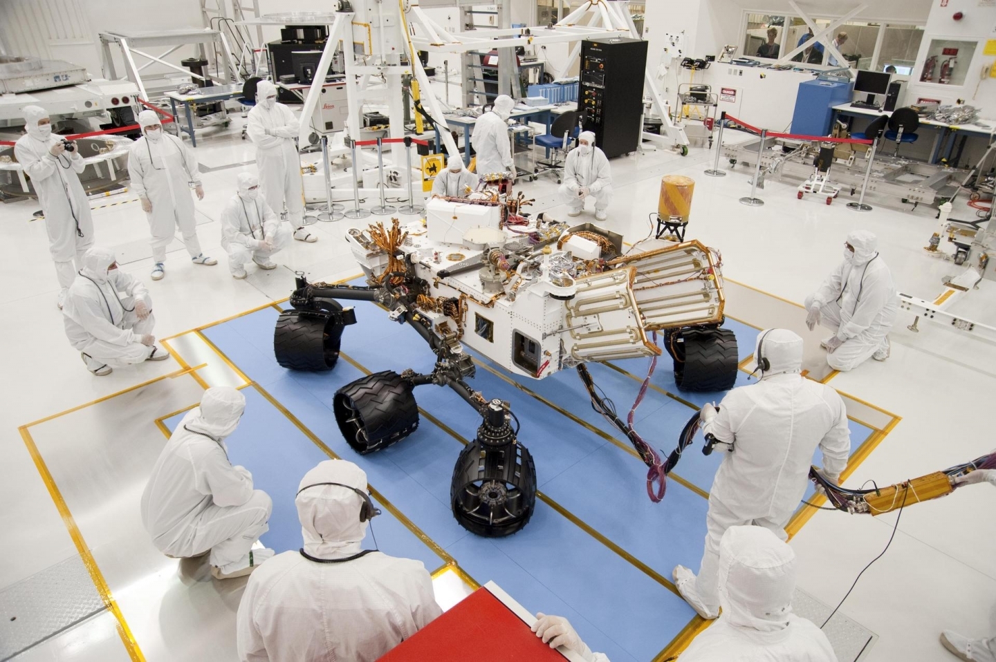 Technicians and engineers in clean-room garb monitor the first drive test of NASA Curiosity rover on July 23, 2010. (NASA/JPL-Caltech)