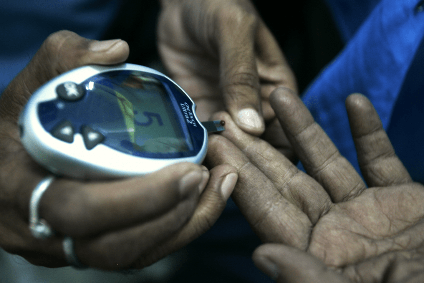 A health worker takes a blood sample from a diabetic patient (AP Photo/Bikas Das)