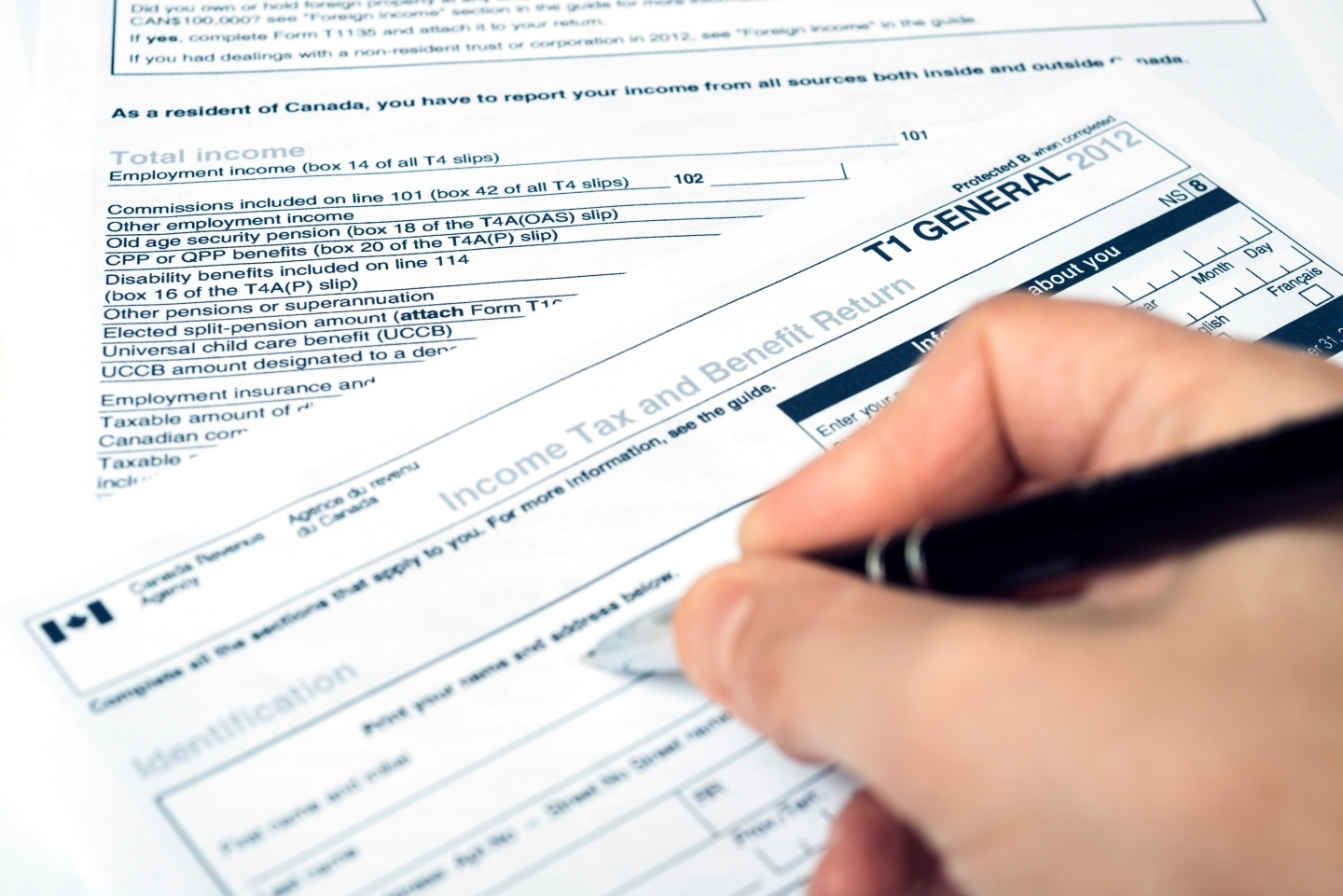 Filling out a Canadian T1 tax form. (Shutterstock)