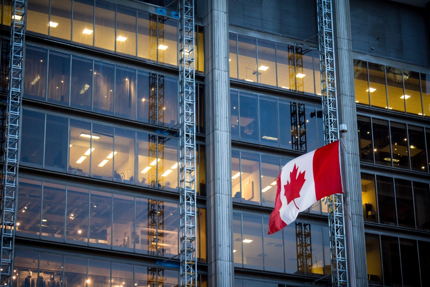 Canadian flag in front of a business building in Toronto, Ontario, Canada (Shutterstock)