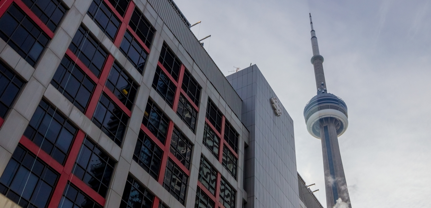 The CN Tower looms over the Canadian Broadcasting Corporation building in downtown Toronto. (Shutterstock)