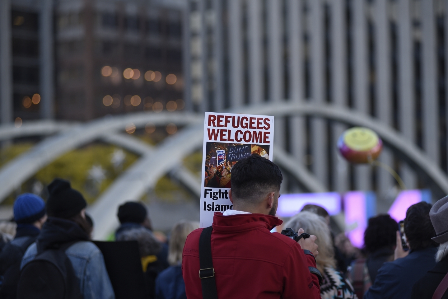 A demonstrator holds a sign welcoming refugees to North America during a protest rally on November 13, 2016 in Toronto, Canada. (Shutterstock)