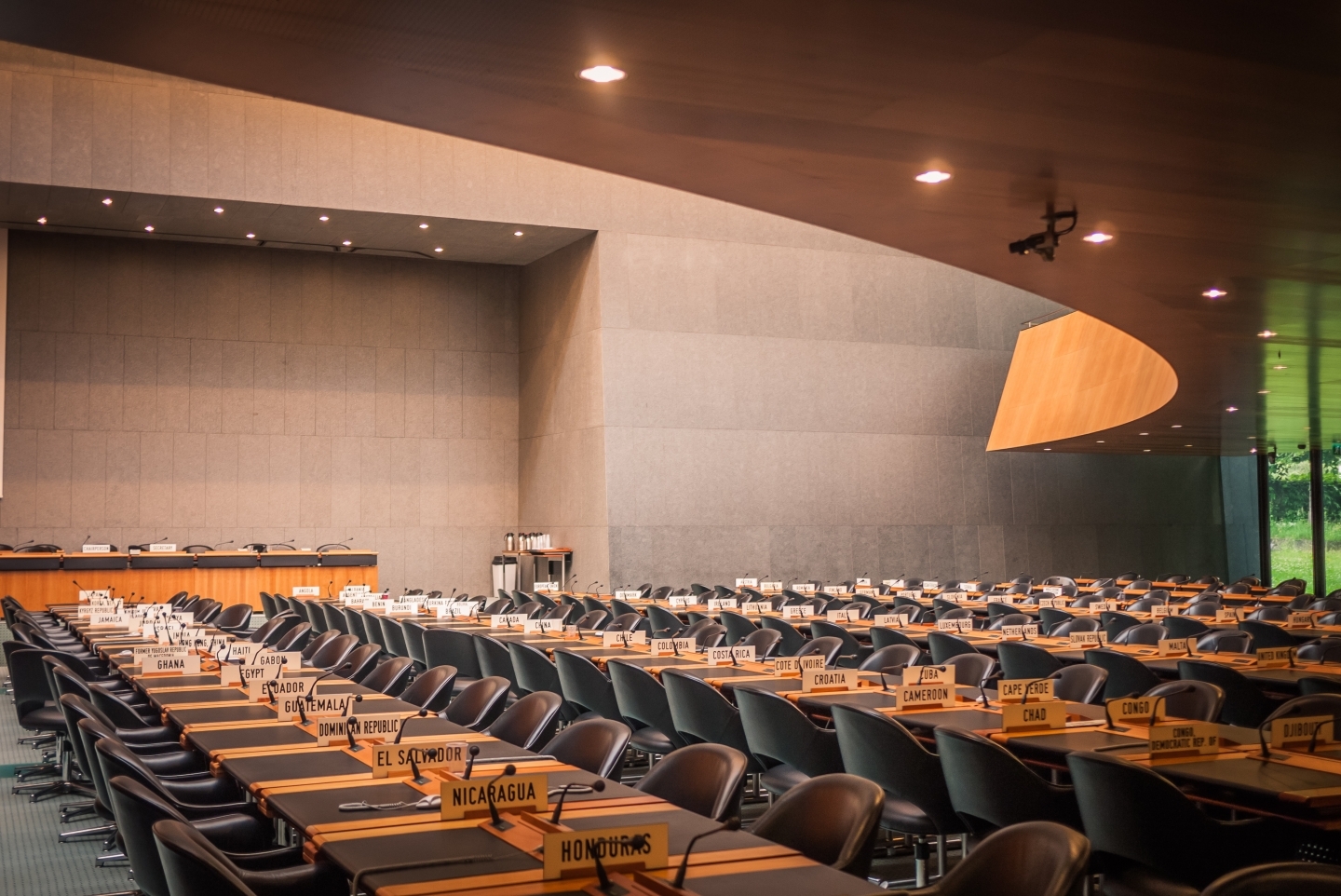 Meeting room with WTO members' nameplates on the desks at the WTO headquarters in Geneva, Switzerland.