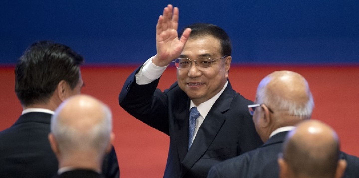 Chinese Premier Li Keqiang, center, waves as he leaves the Inaugural Meeting of the Board of Governors of the Asian Infrastructure Investment Bank (AIIB) in Beijing, China, Saturday, Jan. 16, 2016. (AP Photo/Mark Schiefelbein, Pool)