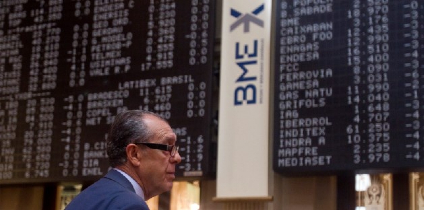 A broker looks on in front of a screen at the Stock Exchange in Madrid. (AP Photo/Paul White)