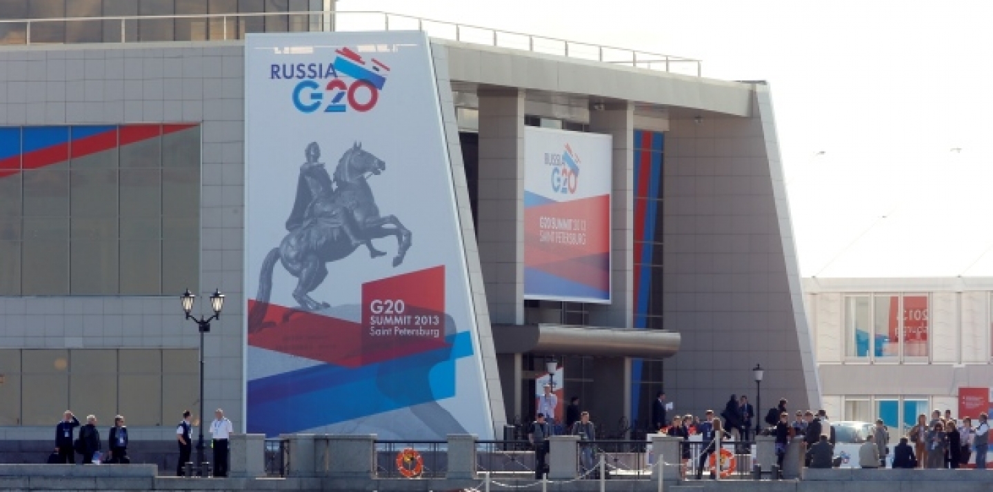 Journalists stand outside the media center of the G20 summit in St. Petersburg, Russia on Wednesday, Sept. 4, 2013. (AP Photo/Dmitry Lovetsky)