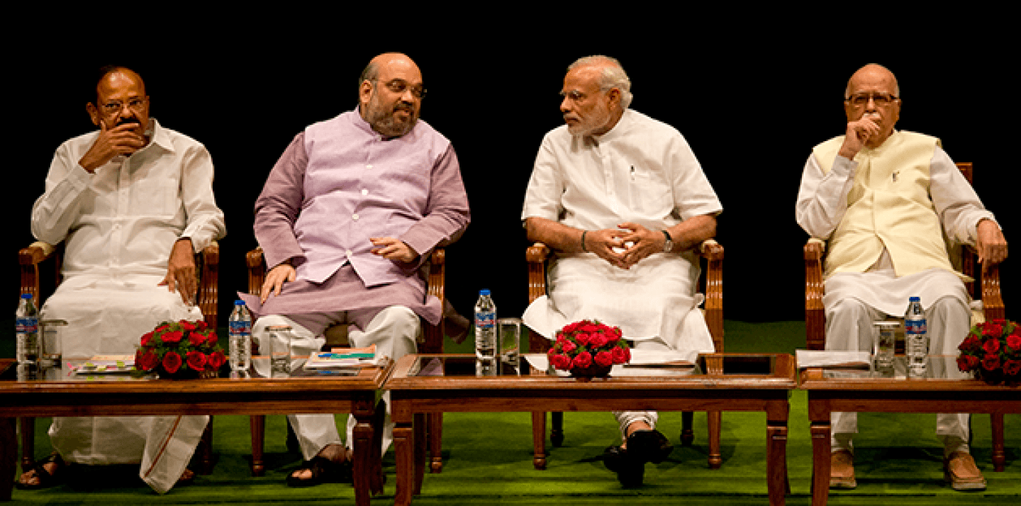 Indian Prime Minister Narendra Modi, second right, talks to Bharatiya Janata Party (BJP) president Amit Shah as party leaders Venkaiah Naidu, left and L.K.Advani, right sit beside during the BJP parliamentary party meeting before the start of second day of the monsoon session of parliament, in New Delhi, India, Wednesday, July 22, 2015.