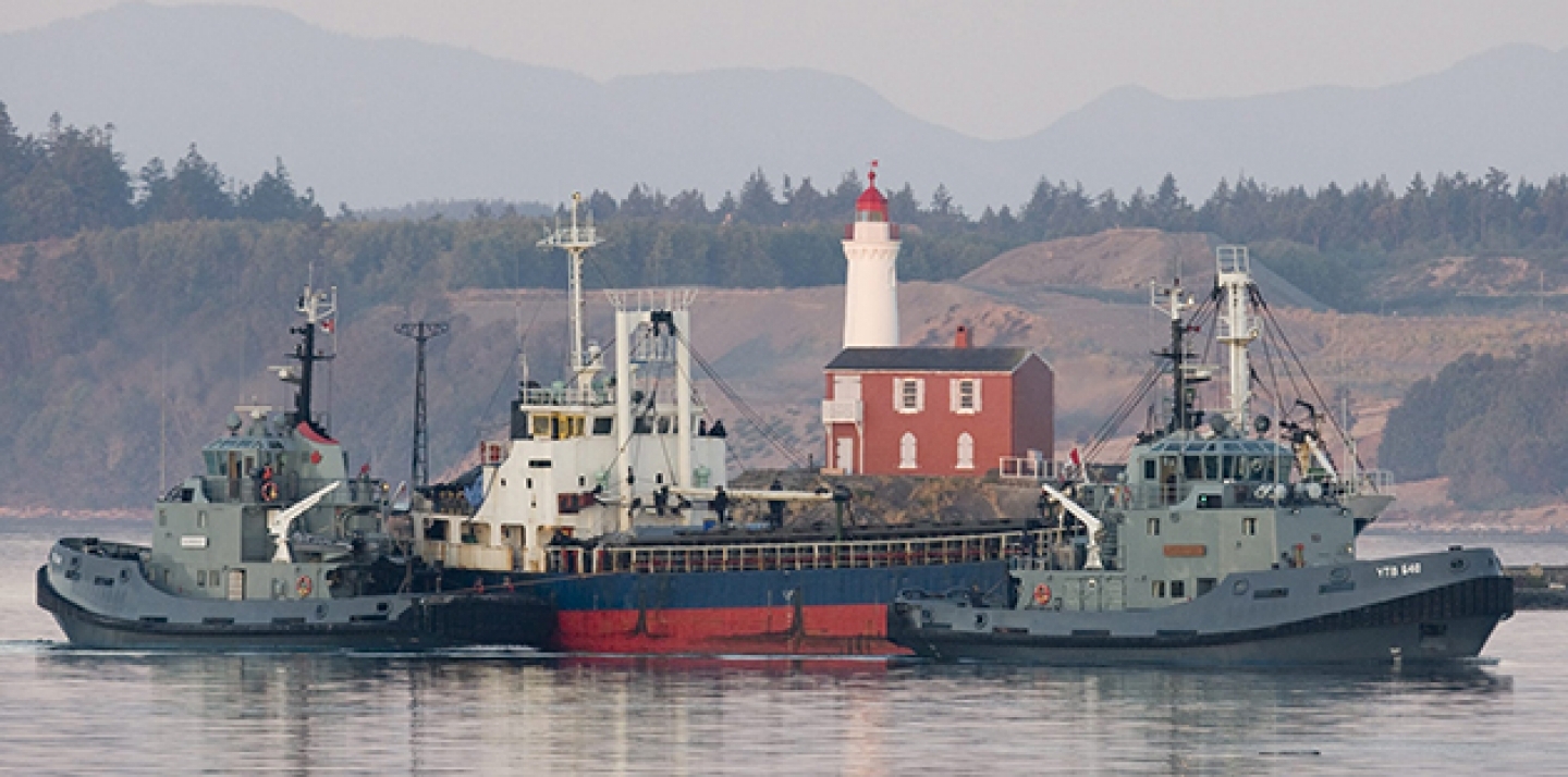The MV Sun Sea is escorted past Fisgard Lighthouse and into CFB Esquimalt in Colwood, British Columbia, Canada on Friday, Aug. 13, 2010.