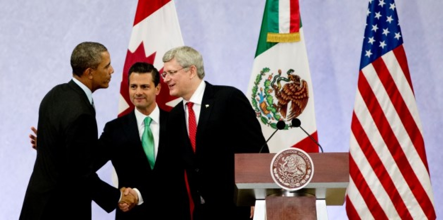 President Barack Obama, left, Mexico's President Enrique Pena Nieto, center, and the Prime Minister of Canada, Stephen Harper, shake hands at the North American Leaders Summit. (AP Photo/Eduardo Verdugo)