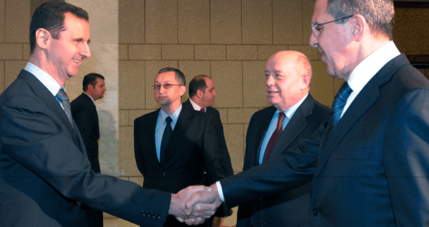 Syrian President Bashar Assad, left, shakes hands with Russian Foreign Minister Sergey Lavrov, right, as Russian Foreign Intelligence chief Mikhail Fradkov smiles second right, in Damascus, Syria on Tuesday, Feb. 7, 2012. (AP/STR)