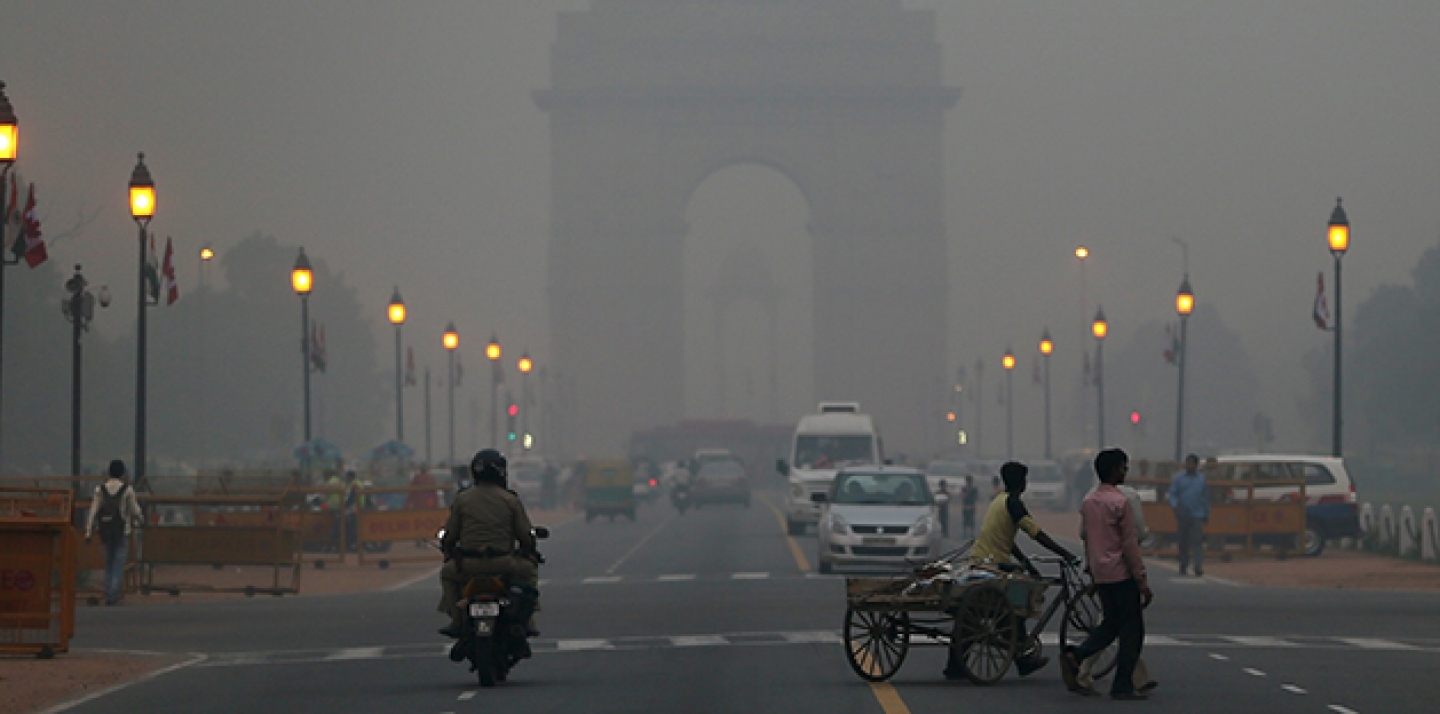 Traffic moves in front of the landmark India Gate monument enveloped by a blanket of smog. (AP Photo/ Manish Swarup)