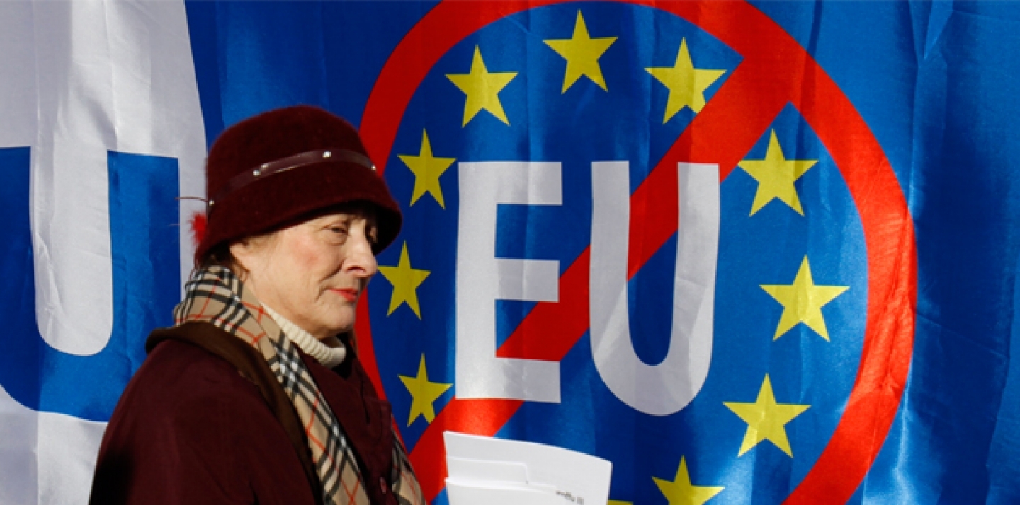 A woman walks past anti-EU banners during a protest in Zagreb, Croatia. Croatia signed an EU accession treaty in 2011 and is set to become a member in July 2013 (AP Photo/Filip Horvat).