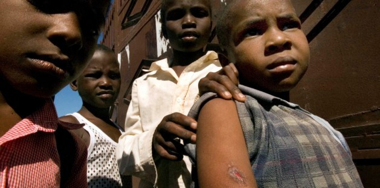Several Haitian children show the wound a stray bullet caused during clashes between armed gangs and U.N. peace keepers at the slum of Cite Soleil, in Port-au-Prince (AP Photo/Ramon Espinosa).