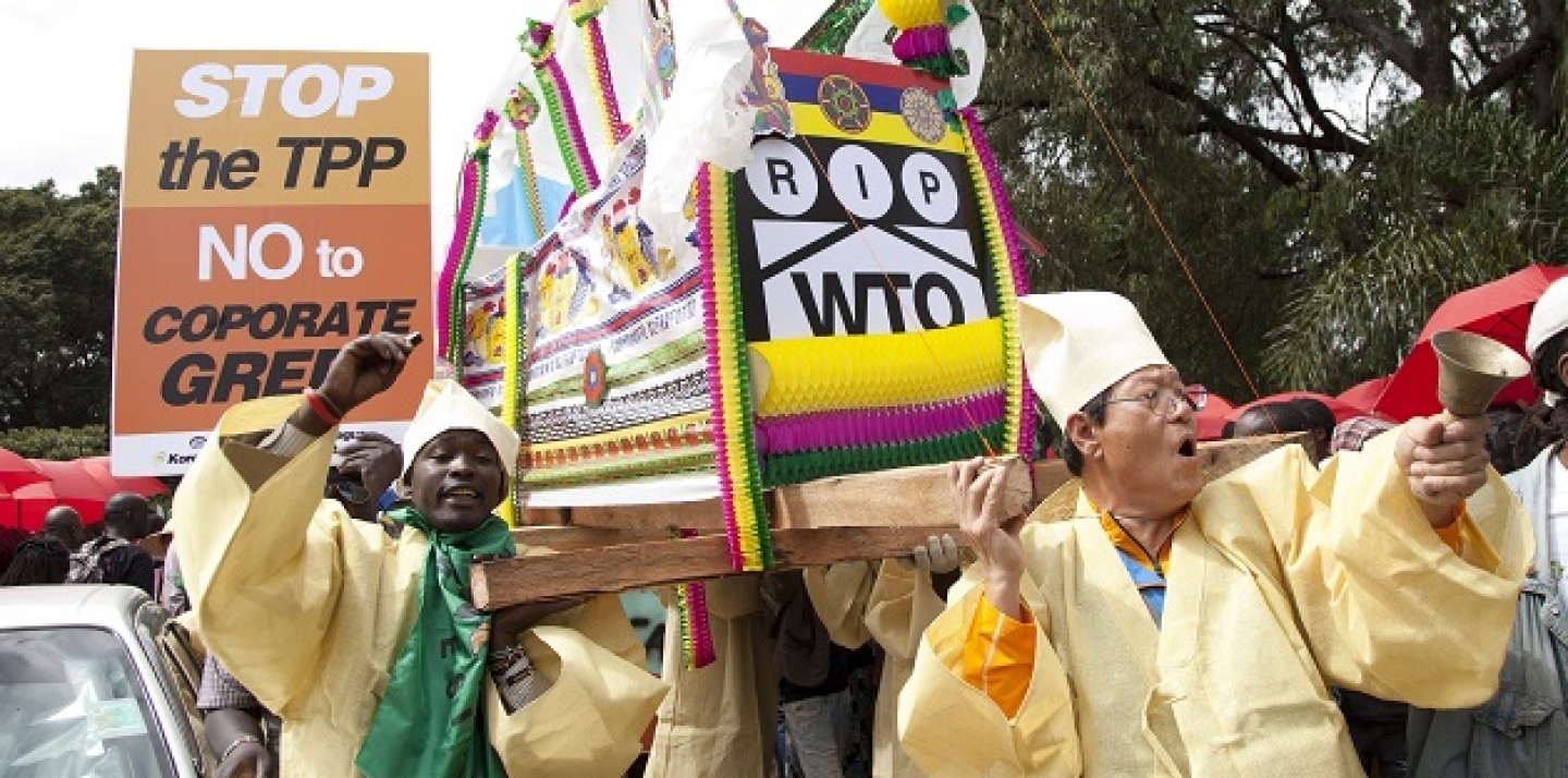 South Korean and Kenyan farmers shout slogans as they carry a coffin representing the WTO during a demonstration in Nairobi, Kenya on Dec. 17, 2015. (AP Photo/Sayyid Azim)