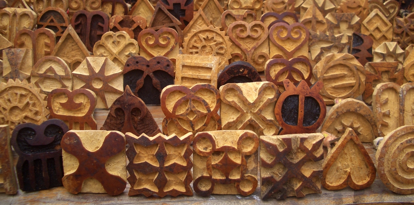 Carved stamps are used to print symbols on traditional Adinkra cloth made by the Ashanti people in Ghana. (Shutterstock)