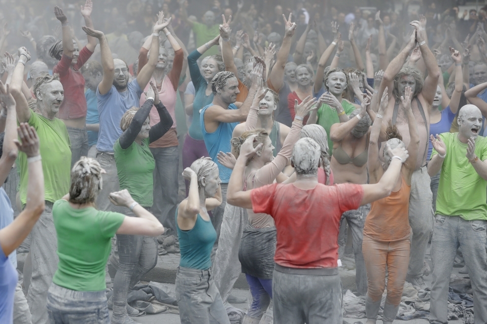 G20 protesters celebrate and shake off clay after a performance in Hamburg (AP Photo/Matthias Schrader)