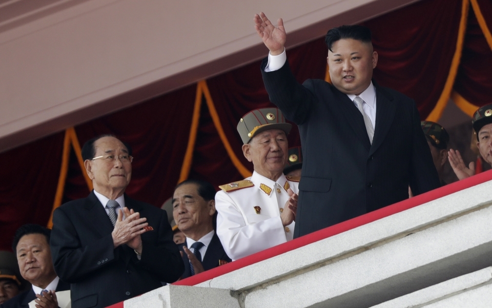 North Korean leader Kim Jong Un waves while officials, from left, Choe Ryong Hae, Kim Yong Nam, Pak Pong Ju, and Hwang Pyong So applaud during a military parade in Pyongyang. (AP Photo/Wong Maye-E, File)