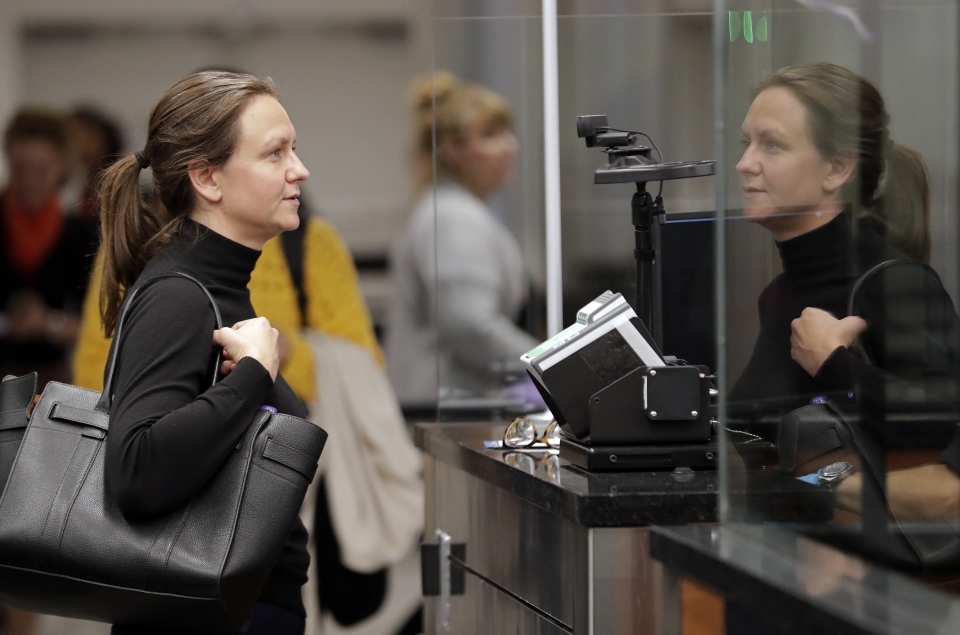 A visitor from Denmark stands in front of a face recognition camera after arriving at customs at Orlando International Airport on June 21, 2018. Florida's busiest airport is becoming the first in the nation to require a face scan of passengers on all arriving and departing international flights. (AP Photo/John Raoux)