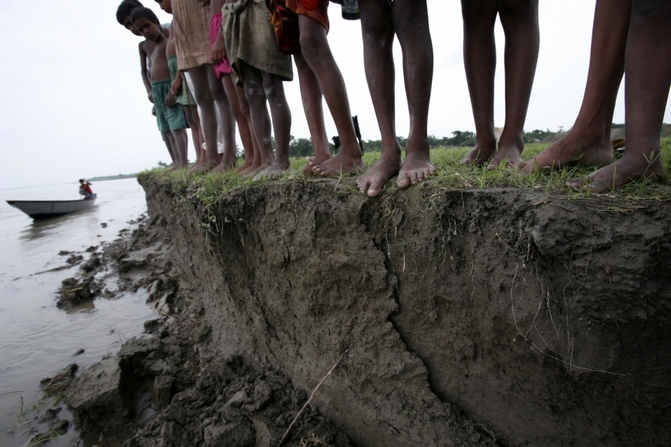 In this 2008 photo, a group of Bangladeshi children stand on the eroding banks of the river Jamuna, in Manikgonj, 40 kilometres, north of Bangladesh capital Dhaka. (AP Photo/Pavel Rahman)