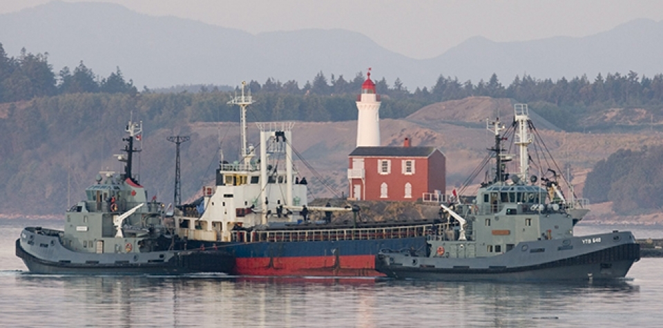 The MV Sun Sea is escorted past Fisgard Lighthouse and into CFB Esquimalt in Colwood, British Columbia, Canada on Friday, Aug. 13, 2010.