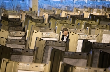 A technician works to prepare voting machines for voters in advance of the 2016 US presidential election. (AP Photo/Matt Rourke)