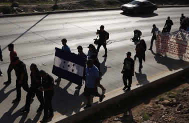 On December 11, 2018, Honduran migrants marched to the US consulate in Tijuana, Mexico, calling for authorities to speed up the asylum application process. (AP Photo/Moises Castillo)