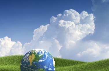 blue sky and fluffy clouds over globe on field