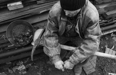 A coal miner takes a break during his shift (Shutterstock)