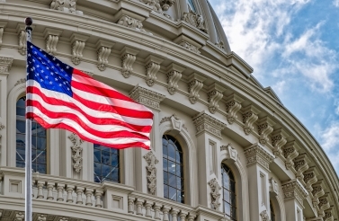 Washington, DC Capitol dome detail with waving American flag
