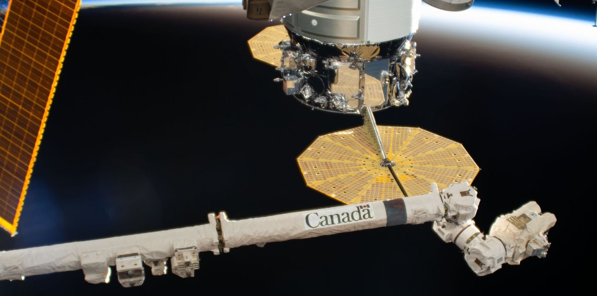 The Canadarm2 robotic arm and the International Space Station soaring above the South Pacific Ocean and into an orbital sunset. (NASA/ZUMA Wire/REUTERS)
