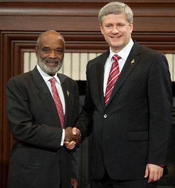 Prime Minister Stephen Harper greets René Préval, President of Haiti, as he arrives for a G-8 Working Session.JPG