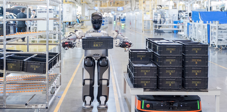 A robot developed by UBTECH moves a load onto an automated guided vehicle at a factory in Ningbo, Zhejiang province, China, August 5, 2024. (Peng Peng, Ni Yanqiang/Zhejiang Daily Press Group via REUTERS)